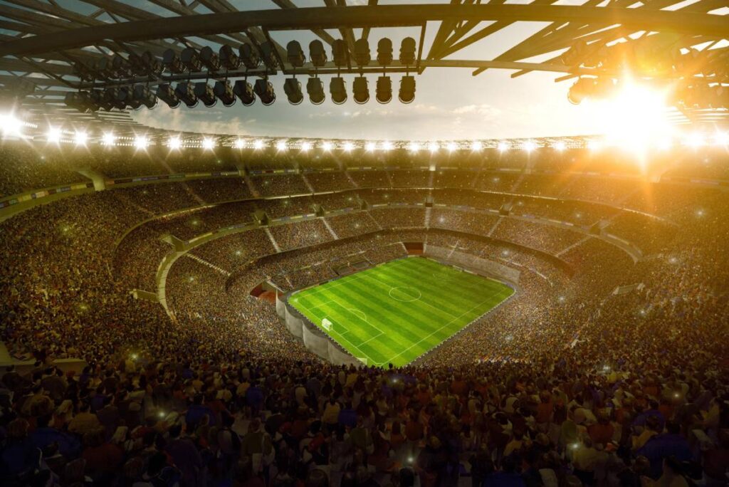 Eine gut ausgeleuchtete Fußballarena mit cinematischer oder filmreifer Atmosphäre.